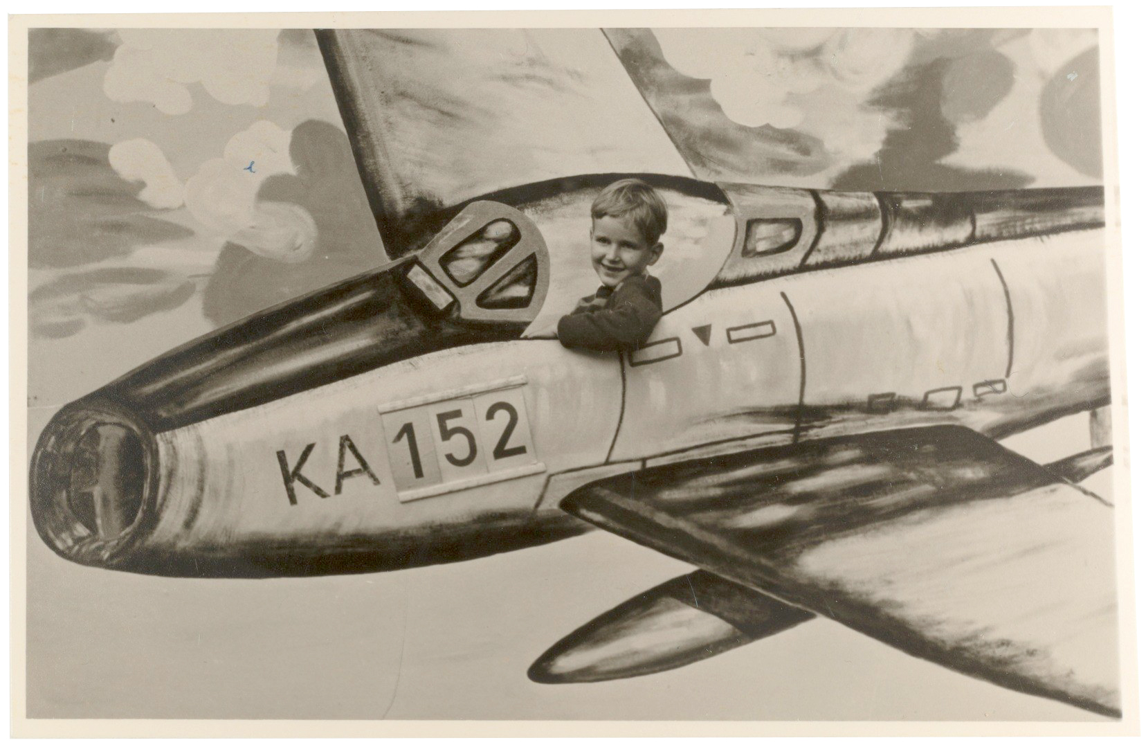 Junge in einer gezeichneten Flugzeugmontage mit der Kennung KA 152